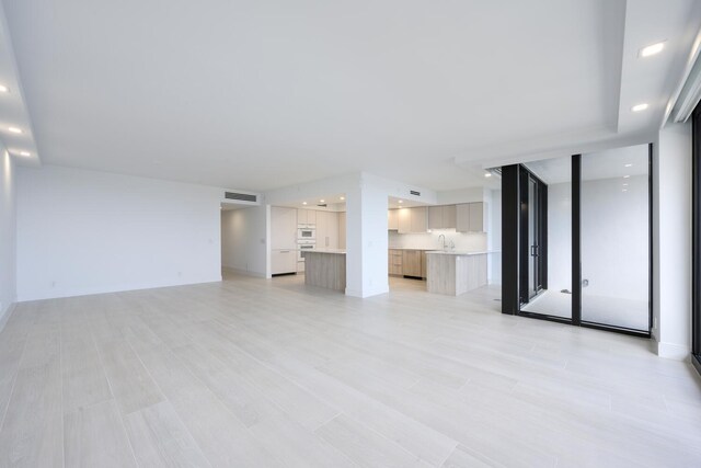 kitchen with white oven, stovetop, kitchen peninsula, and white cabinets