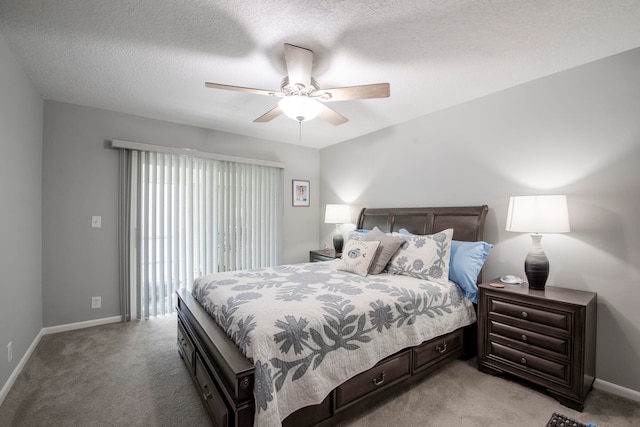 carpeted bedroom featuring ceiling fan and a textured ceiling