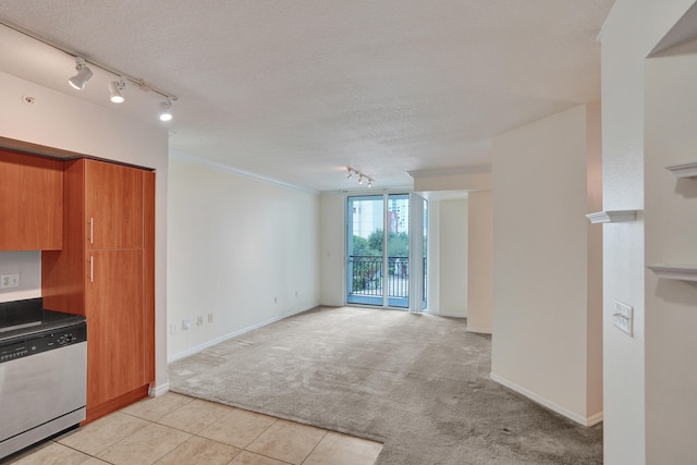 kitchen with dishwasher, a textured ceiling, light colored carpet, and rail lighting