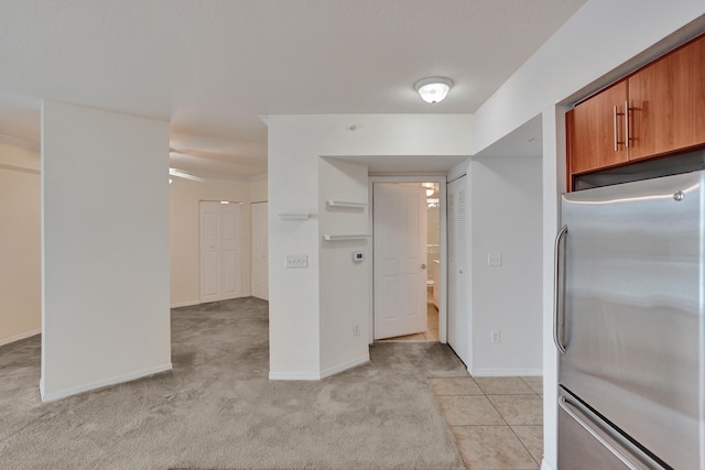 kitchen with light colored carpet and stainless steel refrigerator