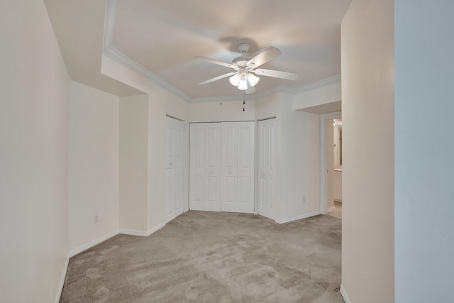 unfurnished bedroom with light carpet, ornamental molding, and ceiling fan