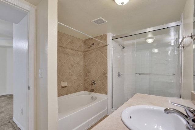 bathroom with tiled shower / bath and vanity