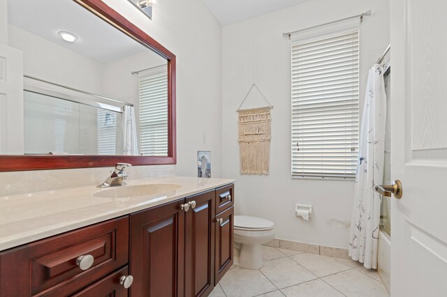 bathroom featuring a tub, tile patterned flooring, and vanity