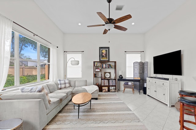 living room featuring light tile patterned flooring and ceiling fan