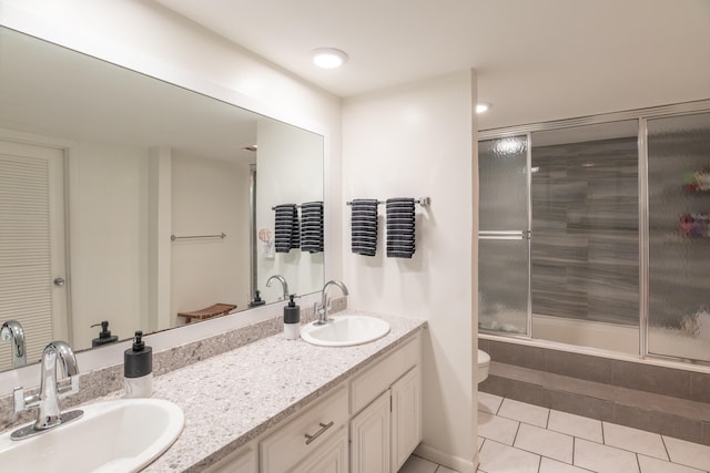 full bathroom with vanity, tile patterned floors, shower / bath combination with glass door, and toilet