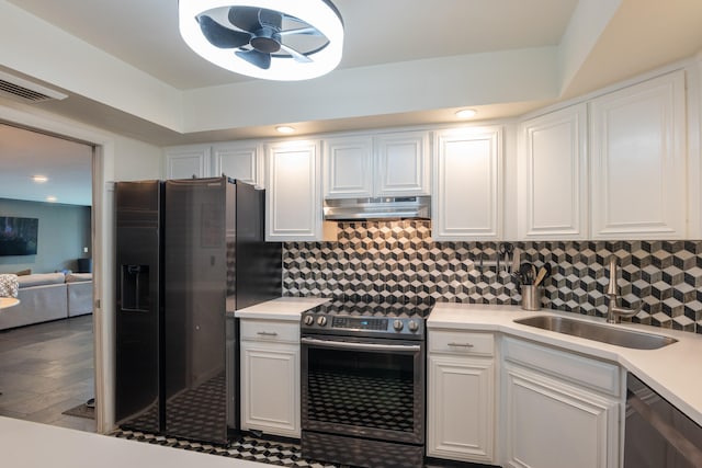 kitchen with appliances with stainless steel finishes, white cabinets, hardwood / wood-style flooring, and sink