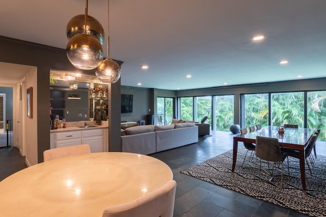 dining space featuring a wealth of natural light, sink, and crown molding