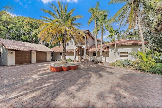 mediterranean / spanish house with a garage