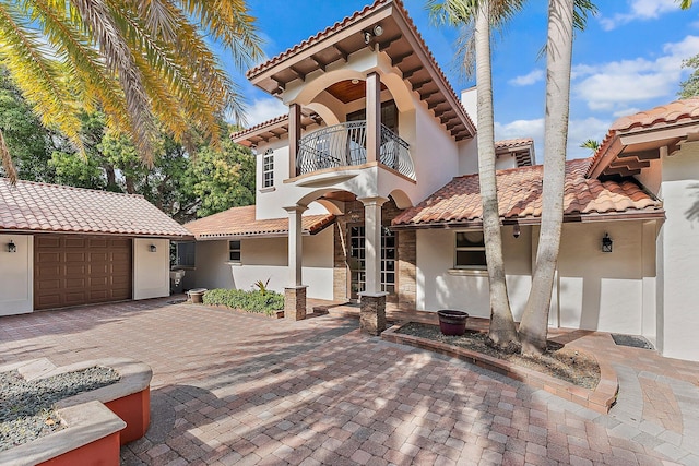 mediterranean / spanish-style house with a balcony and a garage