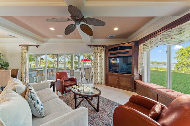 tiled living room with ceiling fan, a textured ceiling, crown molding, and a healthy amount of sunlight