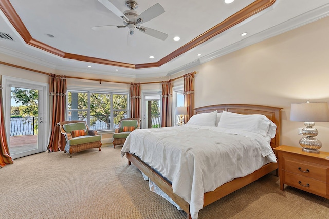 carpeted bedroom featuring access to exterior, a raised ceiling, and crown molding