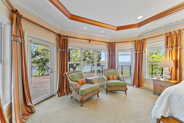 carpeted bedroom with a raised ceiling, crown molding, and access to outside