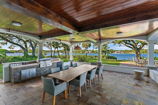 view of patio / terrace featuring area for grilling and a water view