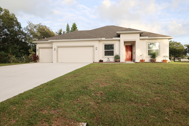 prairie-style house with a garage and a front lawn