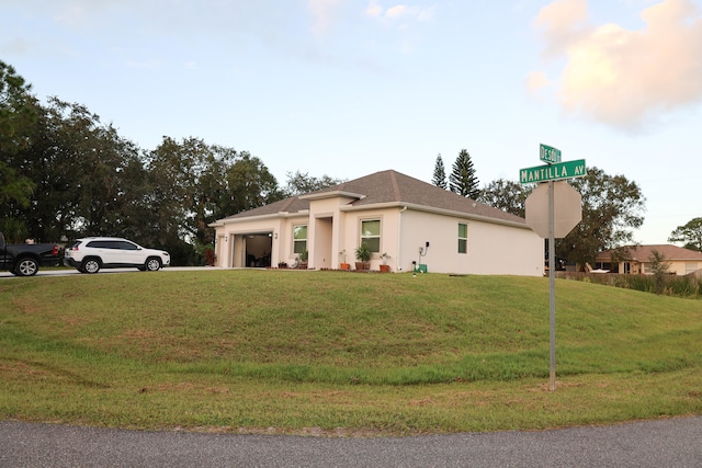 view of property exterior with a yard and a garage