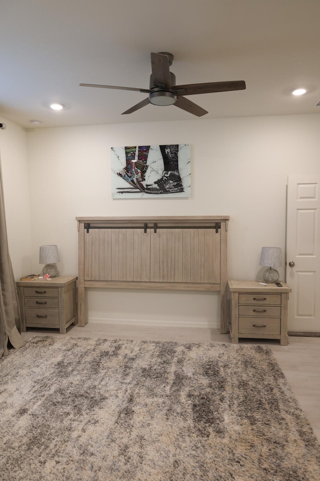 bedroom with ceiling fan and light hardwood / wood-style flooring