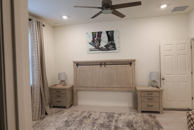 bedroom with light hardwood / wood-style floors and ceiling fan