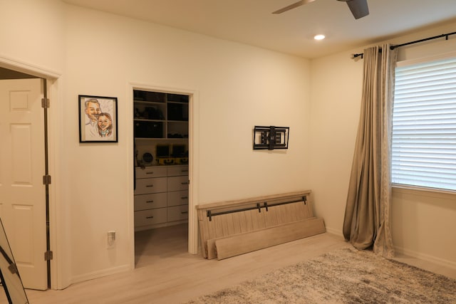 bedroom with light hardwood / wood-style floors, multiple windows, a closet, and ceiling fan