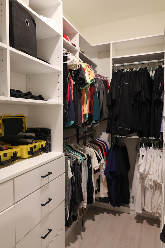 spacious closet with light hardwood / wood-style floors