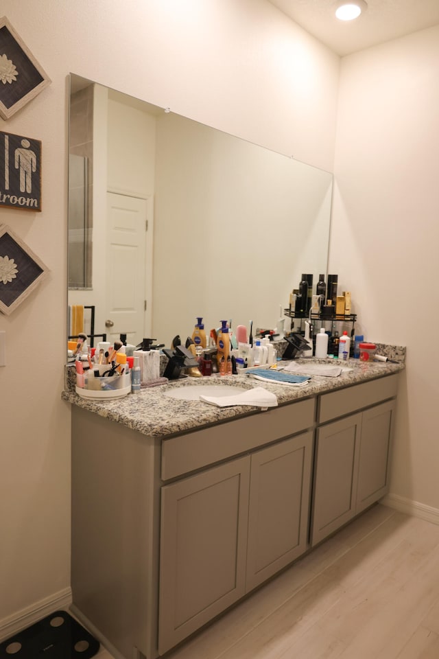 bathroom featuring vanity and hardwood / wood-style flooring