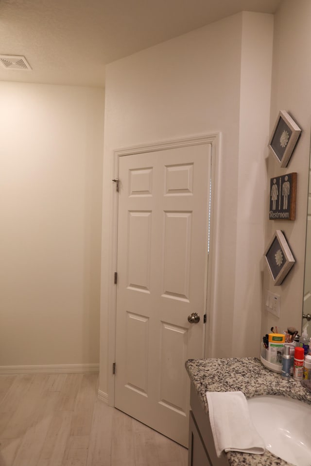 bathroom featuring vanity and wood-type flooring