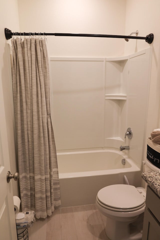 full bathroom featuring vanity, shower / bath combo, and toilet