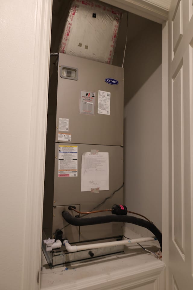 utility room featuring heating unit