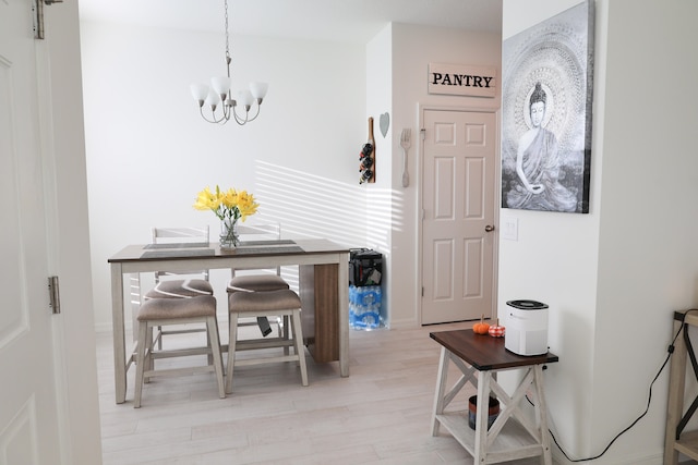 interior space featuring a chandelier and light hardwood / wood-style flooring