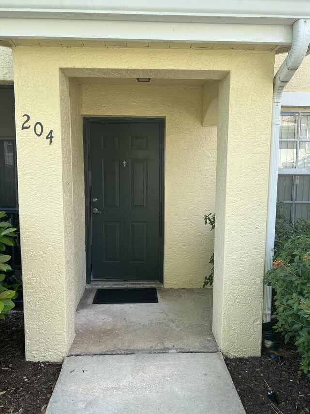 136 SW Peacock Blvd Unit 19-204, Port Saint Lucie, FL 34986 - view of exterior entry with stucco siding