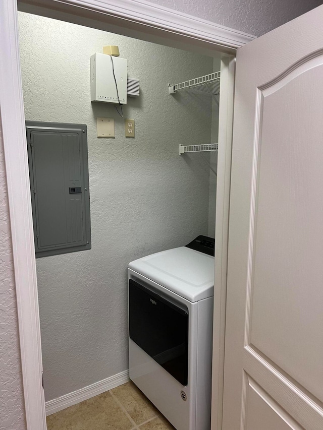 clothes washing area featuring washer / dryer, electric panel, and light tile patterned floors