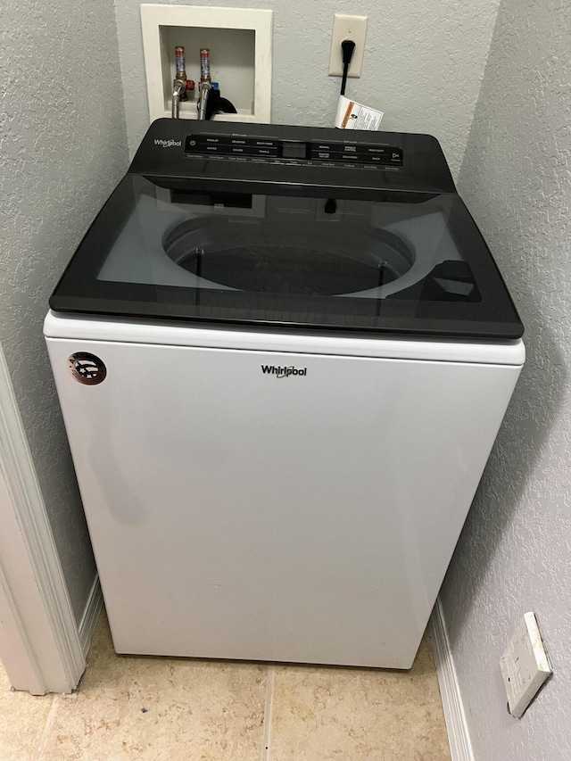 136 SW Peacock Blvd Unit 19-204, Port Saint Lucie, FL 34986 - laundry room with washer / dryer and a textured wall