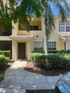 136 SW Peacock Blvd Unit 19-204, Port Saint Lucie, FL 34986 - view of front of house with stucco siding, a tile roof, and a balcony