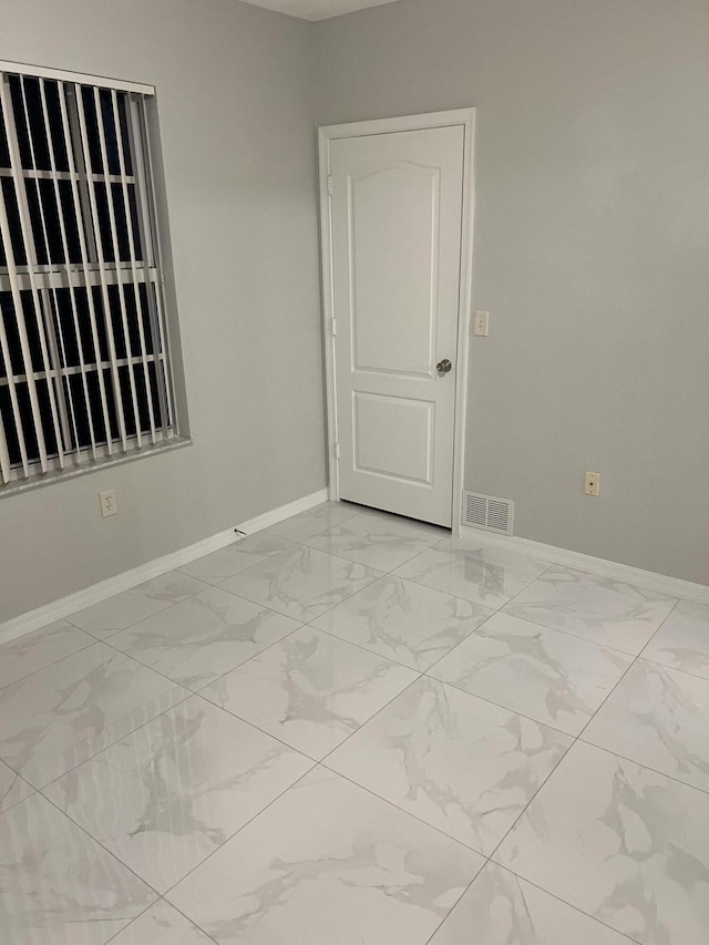 136 SW Peacock Blvd Unit 19-204, Port Saint Lucie, FL 34986 - spare room featuring light marble finish floors and baseboards