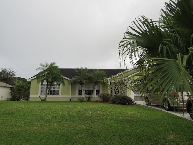 ranch-style home with a front lawn