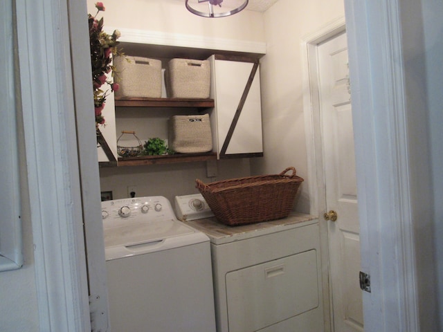 clothes washing area featuring washer and clothes dryer