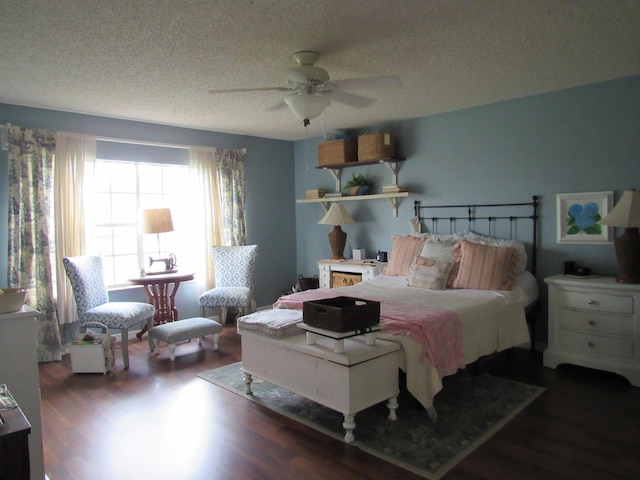 bedroom with dark wood-type flooring, ceiling fan, and a textured ceiling