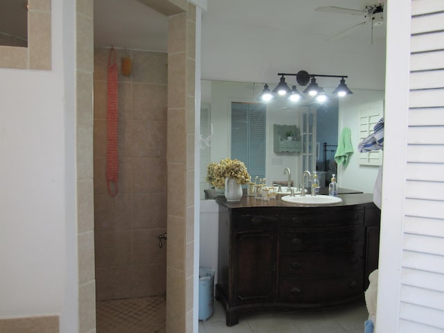 bathroom featuring vanity, ceiling fan, a tile shower, and tile patterned floors