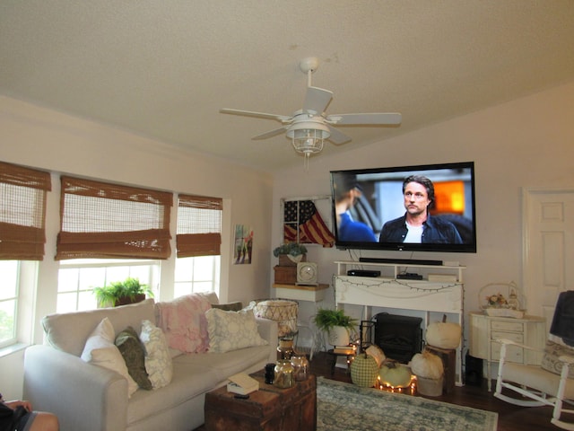 living room with ceiling fan, hardwood / wood-style flooring, and lofted ceiling