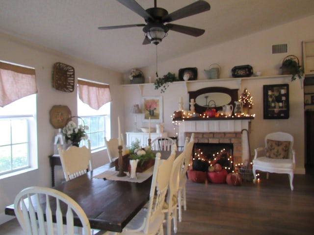 dining room with lofted ceiling, a healthy amount of sunlight, hardwood / wood-style flooring, and ceiling fan