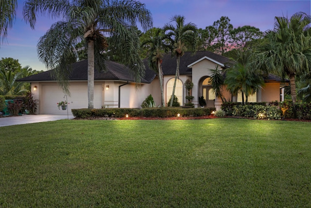 view of front facade featuring a yard and a garage