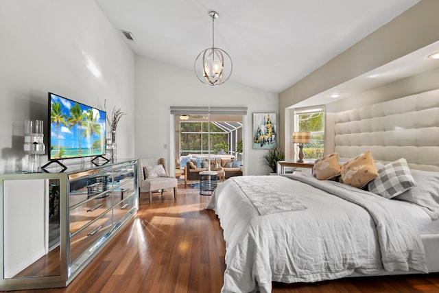 bedroom featuring dark wood-type flooring, vaulted ceiling, multiple windows, and a chandelier