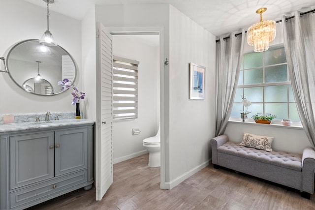 bathroom with vanity, toilet, wood-type flooring, and plenty of natural light