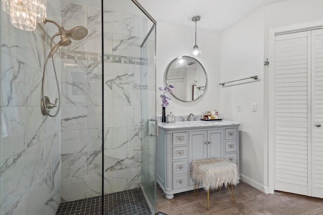 bathroom featuring vanity, hardwood / wood-style flooring, and a shower with door