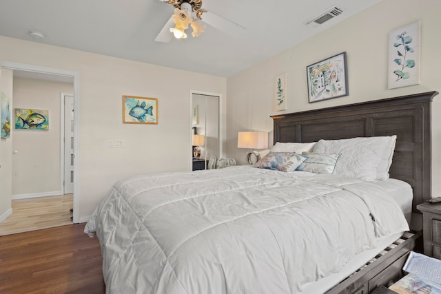 bedroom with ceiling fan, a closet, and dark hardwood / wood-style flooring