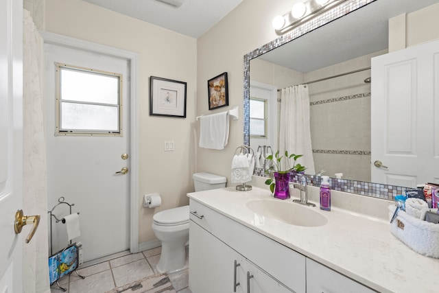 bathroom with vanity, a shower with curtain, toilet, and tile patterned floors