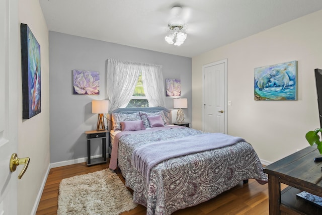 bedroom with hardwood / wood-style flooring