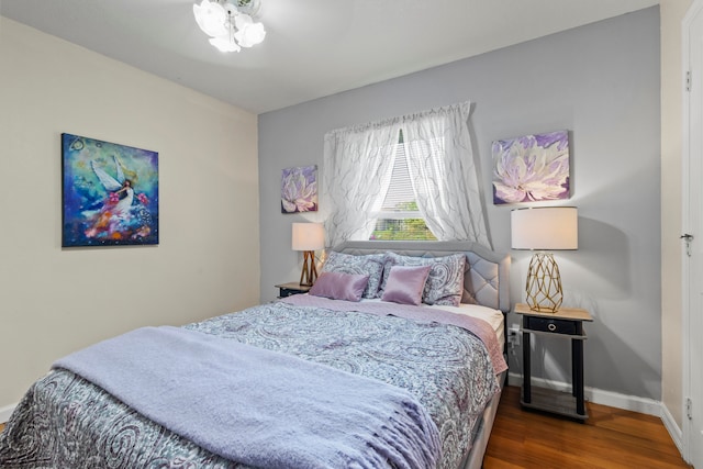 bedroom with hardwood / wood-style flooring