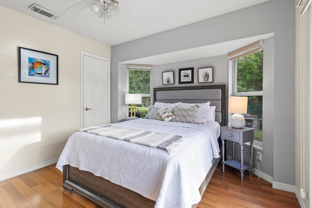 bedroom with wood-type flooring and ceiling fan