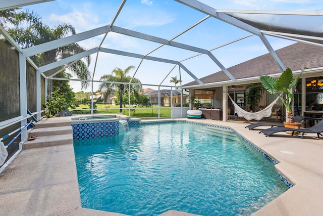 view of swimming pool with an in ground hot tub, a patio, and a lanai