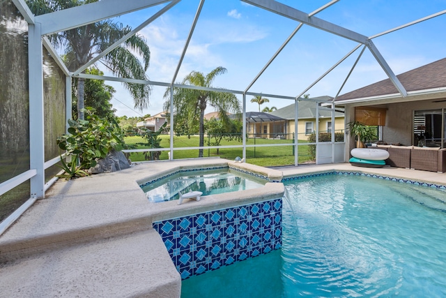 view of pool with an in ground hot tub, a patio, a lanai, and a lawn